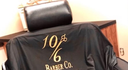 Black barber chair with logo at 10/6 Barber Company in Belleville, Ontario, CA.