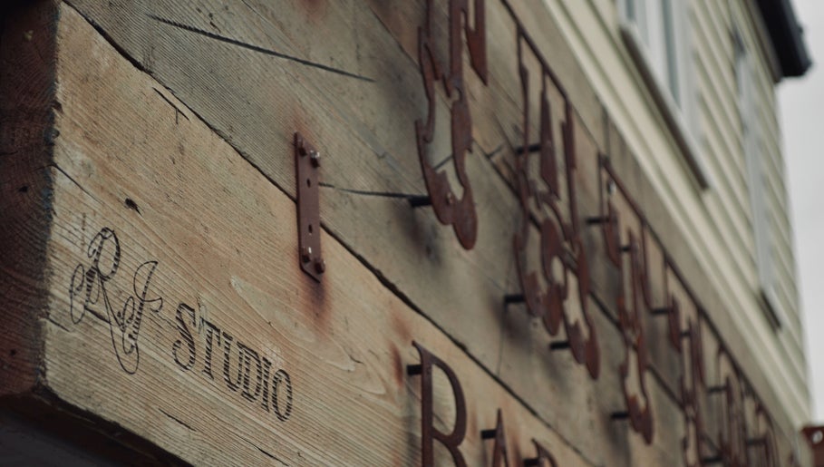 Close-up of R.I Studio's rustic wooden sign in Cambridge, England, GB.