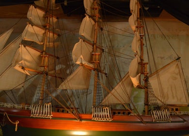 Vintage ship model displayed at R.I Studio - Hairdressers, Tattoos & Piercings, Cambridge, England, GB.