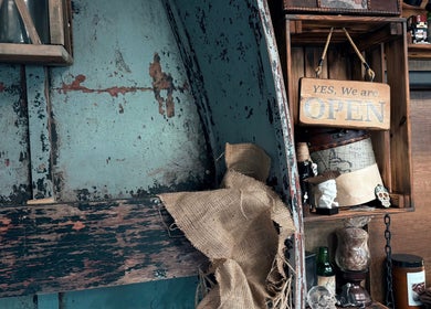 Rustic interior of R.I Studio - Hairdressers, Tattoos & Piercings, Cambridge, England, GB, featuring open sign.