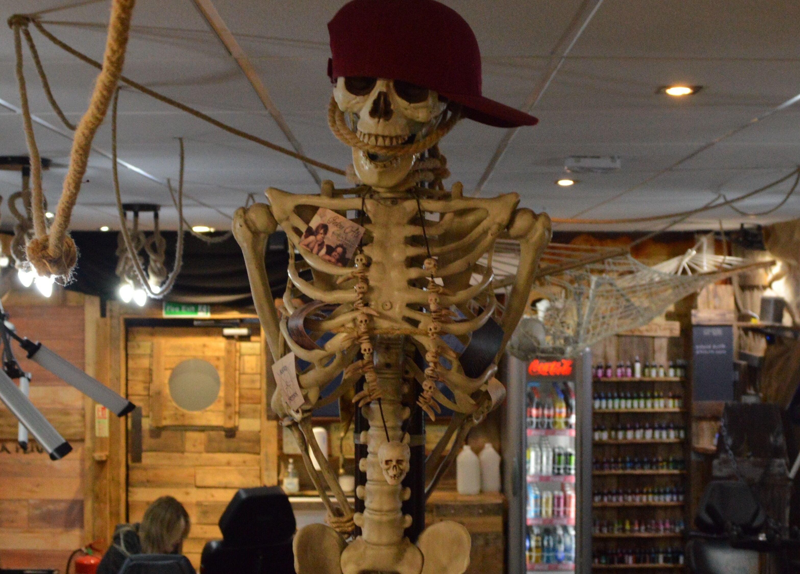 Quirky interior with a skeleton and eclectic decor at R.I Studio - Hairdressers, Tattoos & Piercings, Cambridge, England, GB.