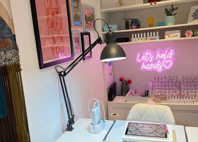 Trendy nail art studio at Queen B Nail Artistry, London, England, GB with modern decor and colorful polishes.