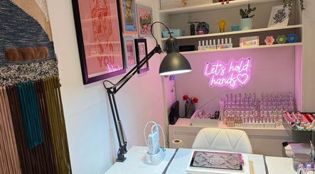 Trendy nail art studio at Queen B Nail Artistry, London, England, GB with modern decor and colorful polishes.
