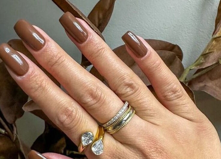 Elegant brown manicured nails at Loven Beauty Inc, Vaughan, Ontario, CA, showcasing chic style and luxury rings.
