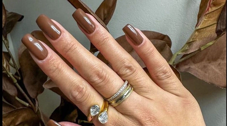 Elegant brown manicured nails at Loven Beauty Inc, Vaughan, Ontario, CA, showcasing chic style and luxury rings.