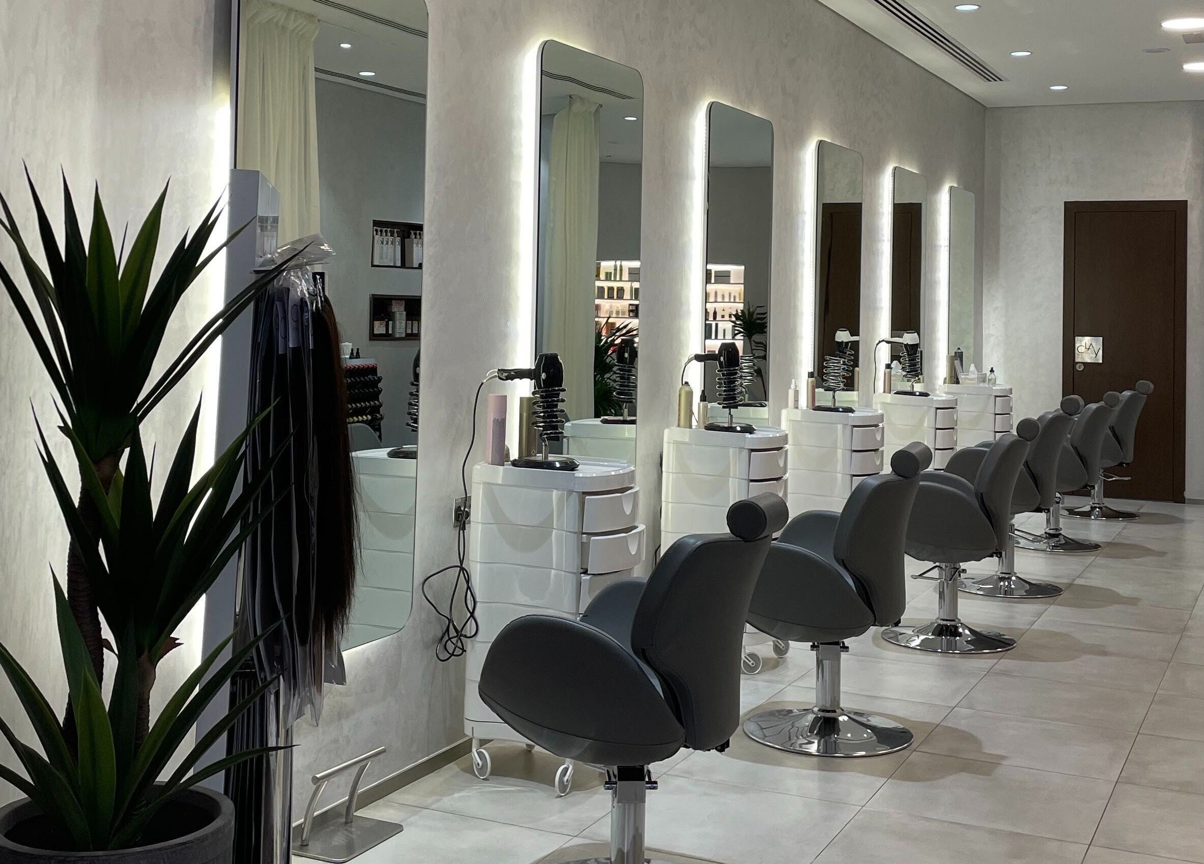 Modern salon chairs at Clay Beauty Lounge - Khaldiya in Abu Dhabi, AE, showcasing sleek and inviting design.