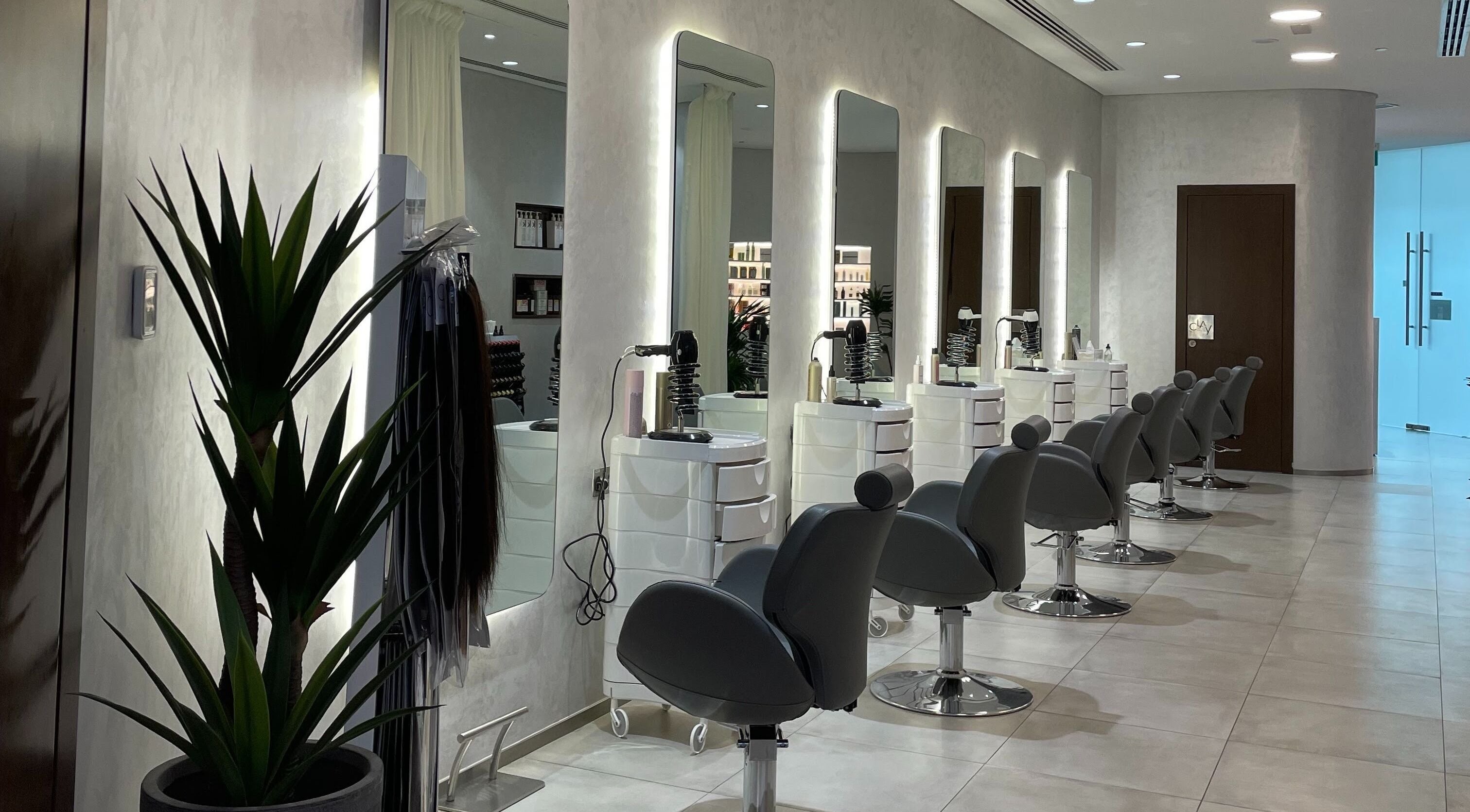 Modern salon chairs at Clay Beauty Lounge - Khaldiya in Abu Dhabi, AE, showcasing sleek and inviting design.
