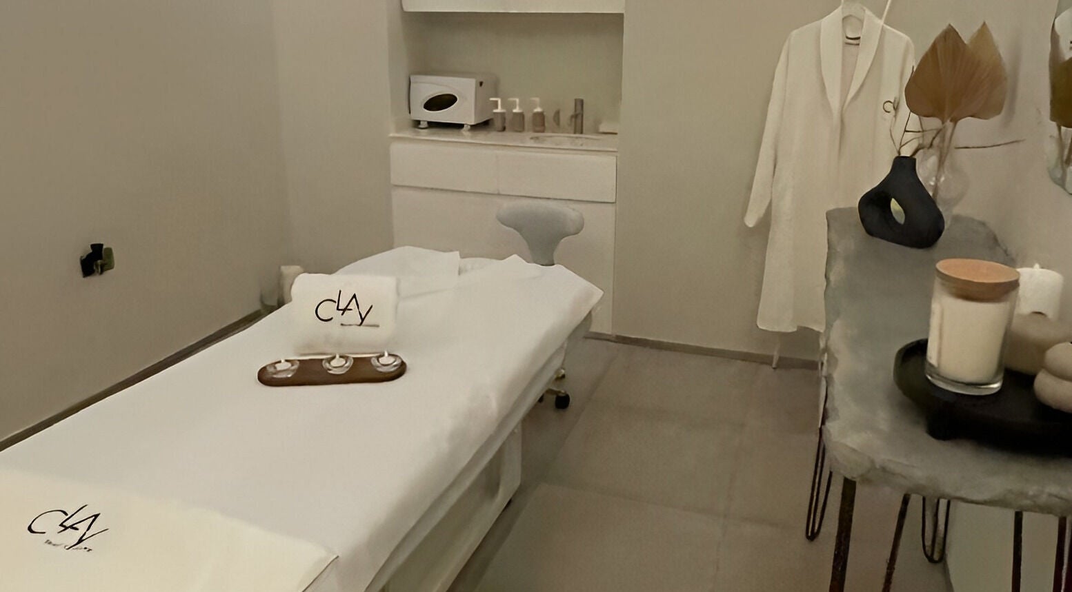 Relaxing spa room at Clay Beauty Lounge - Khaldiya in Abu Dhabi, AE, featuring a treatment bed and plush decor.