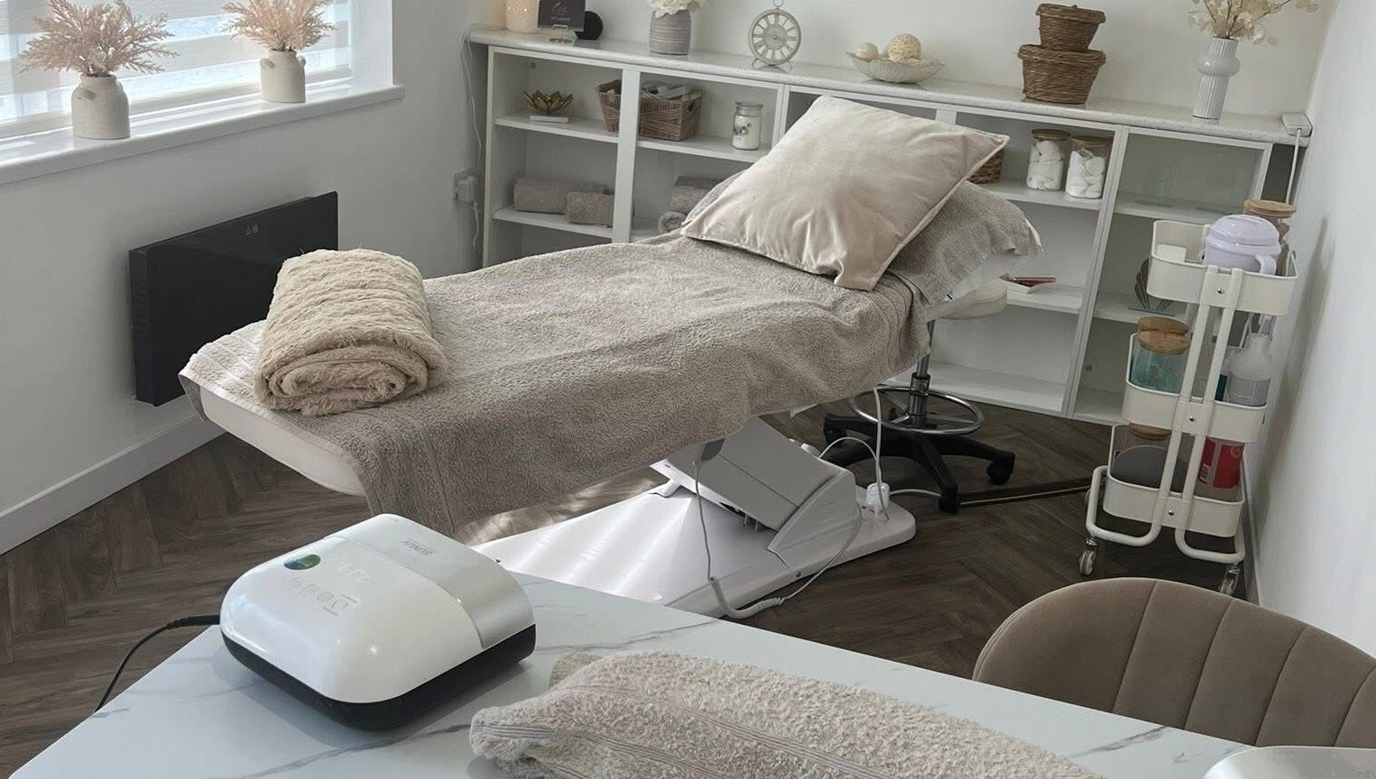 Relaxing beauty treatment room at Chelle's Beauty, Lytham St Anne’s, England, GB with massage bed and decor.