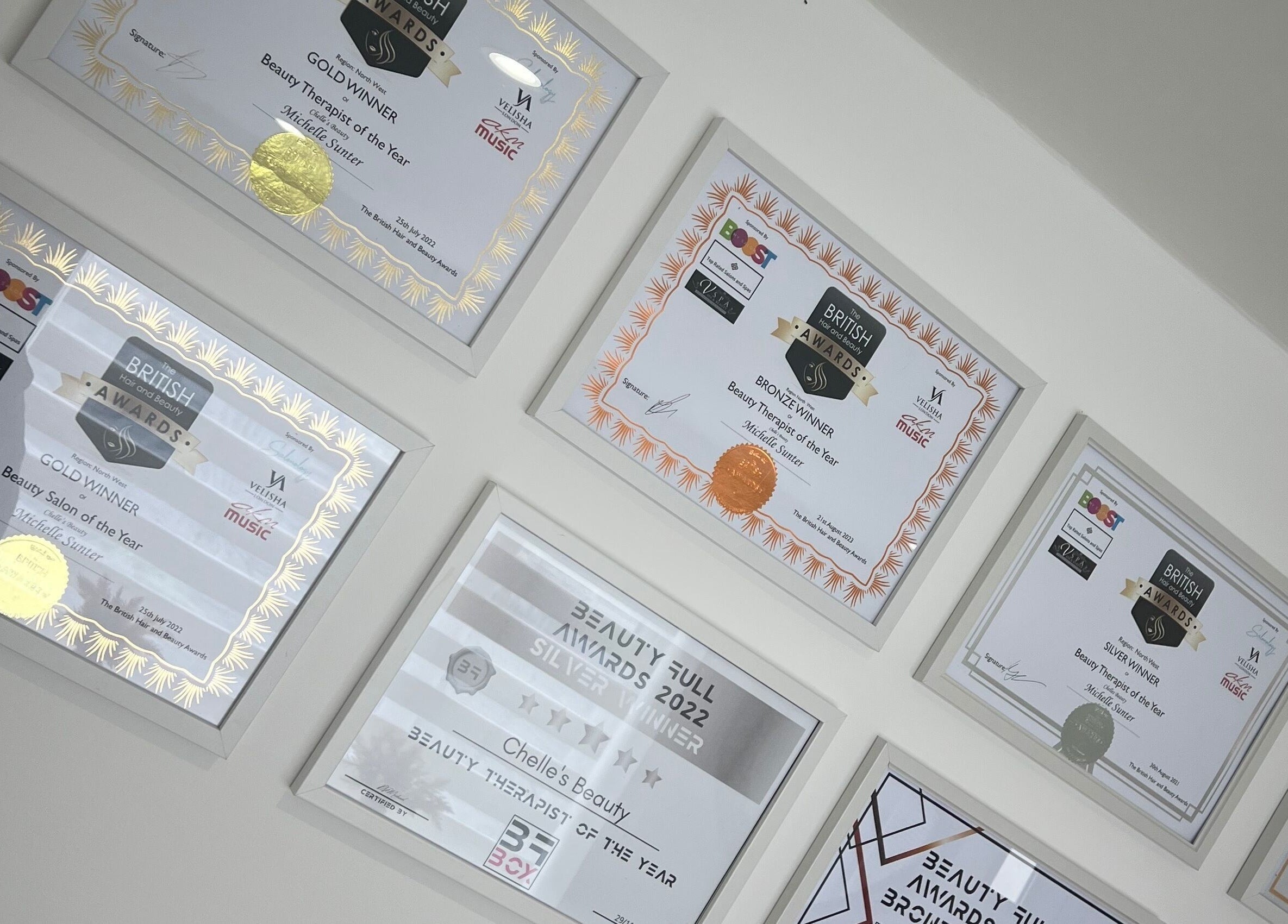 Award frames at Chelle's Beauty, Lytham St Anne’s, England, GB showcasing achievements.