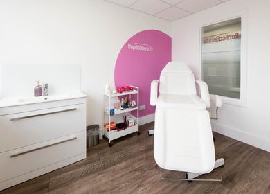 Bright and modern treatment room at Replica Beauty, London, England, GB, featuring a white reclining chair.