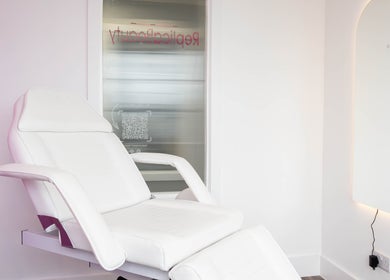Luxurious treatment chair at Replica Beauty in London, England, GB showcasing a modern, serene ambiance.