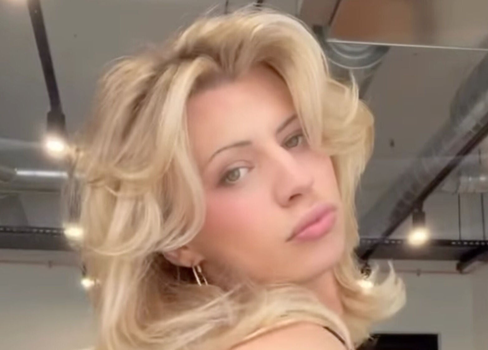 Elegant blonde hairstyle at MOUR Hair in London, England, GB with modern salon background.