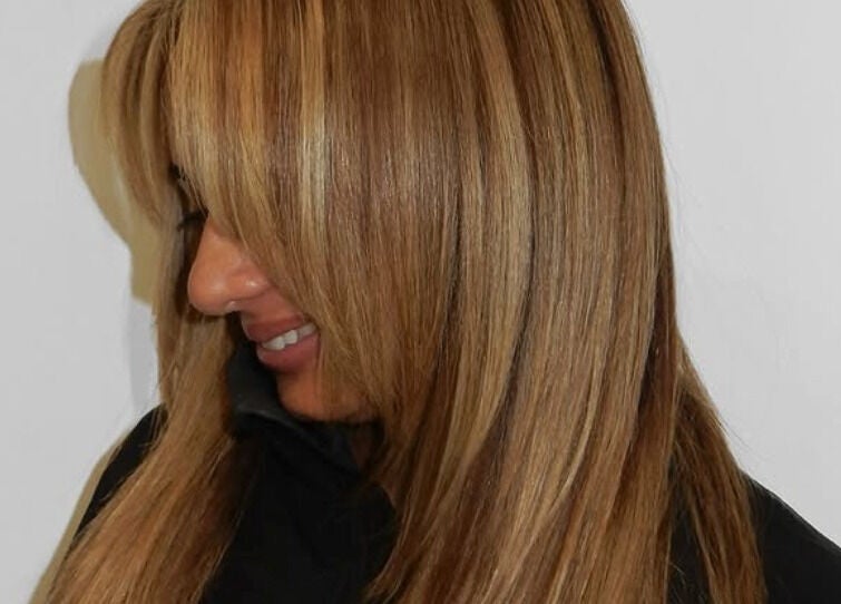 Woman with sleek, golden blonde hair at MOUR Hair, London, England, GB.