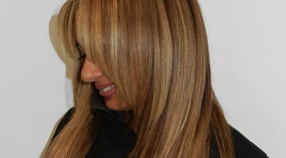 Woman with sleek, golden blonde hair at MOUR Hair, London, England, GB.