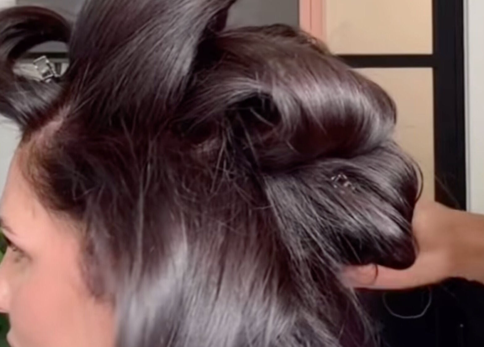 Hair styling at MOUR Hair, London, England, GB, showcasing intricate dark hair design.