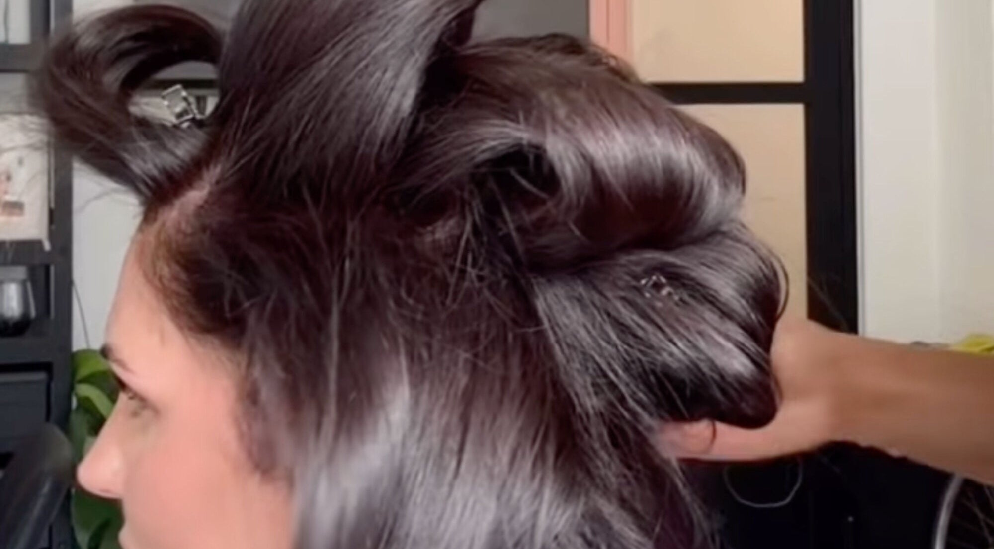 Hair styling at MOUR Hair, London, England, GB, showcasing intricate dark hair design.