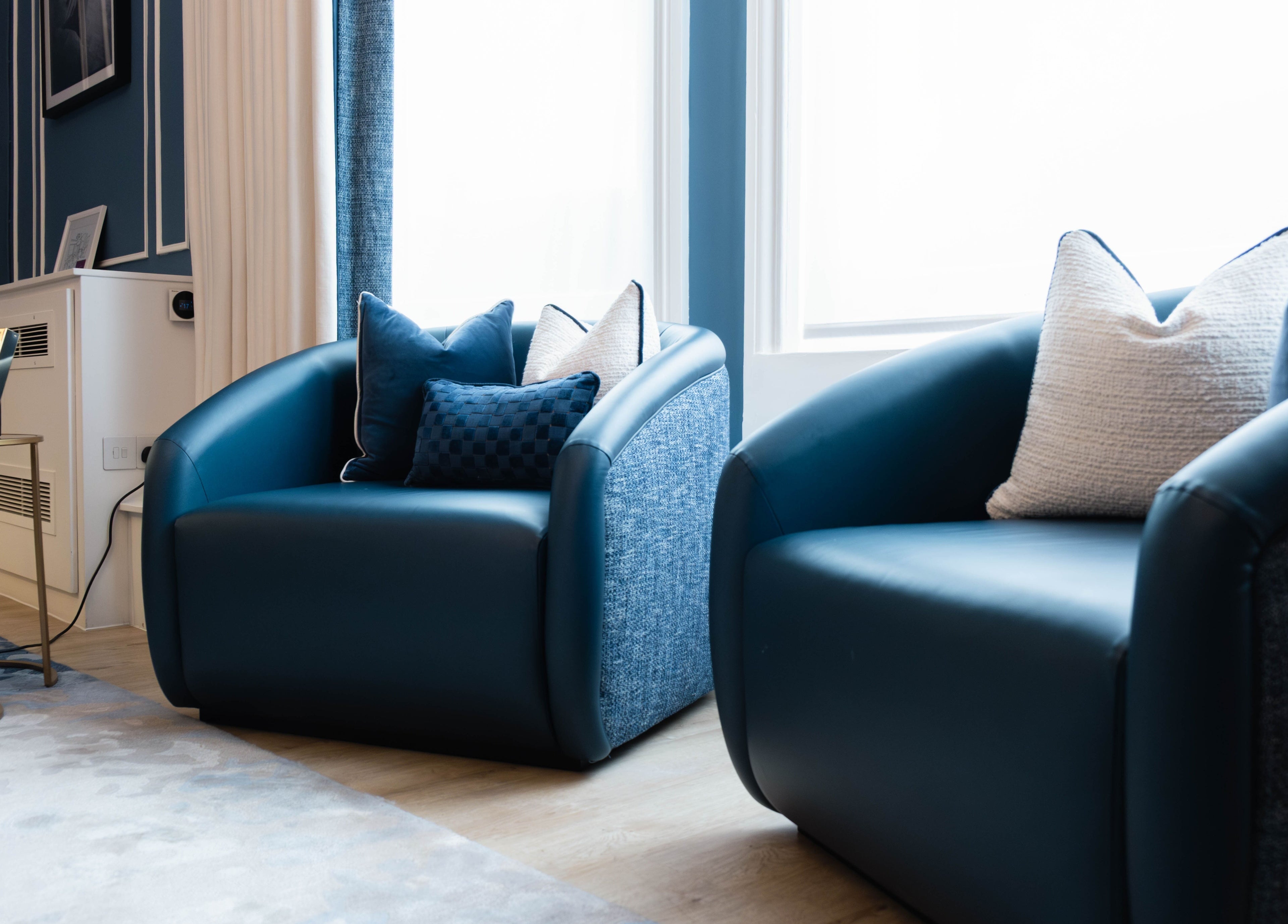 Elegant lounge chairs at ShamseAesthetics Harley Street, London, England, GB create a welcoming atmosphere.