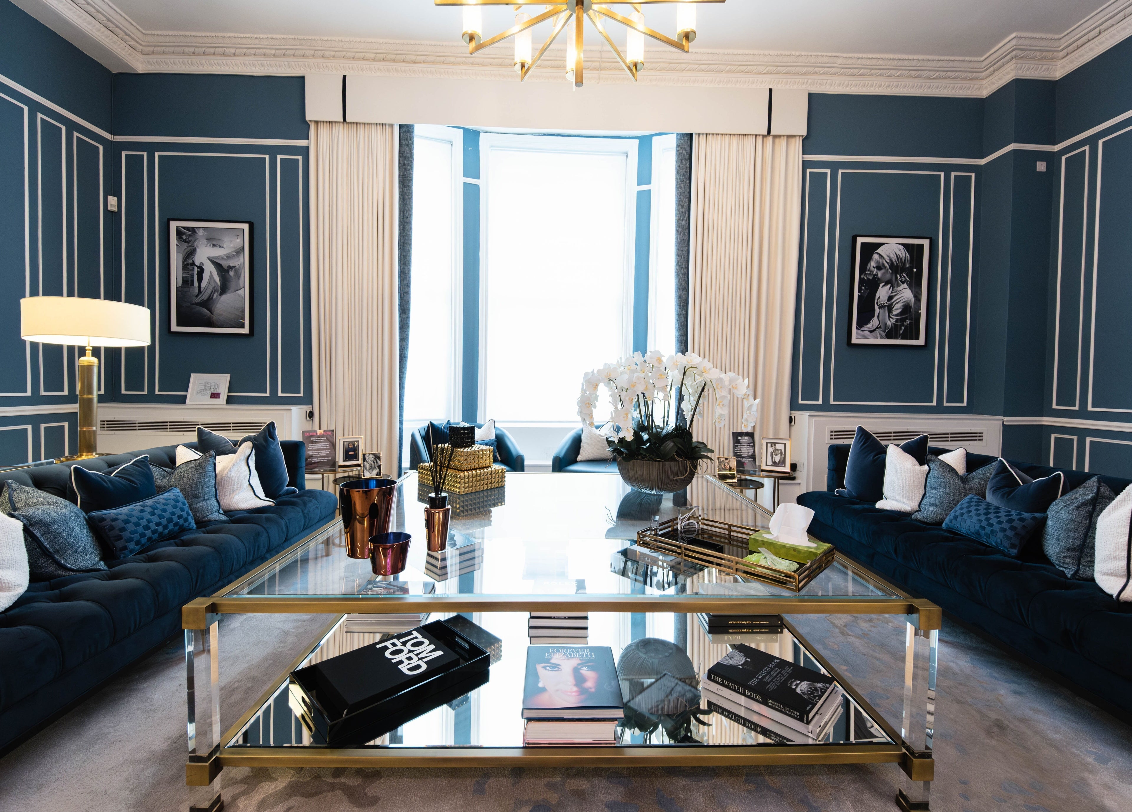 Elegant lounge at ShamseAesthetics Harley Street, London, England, GB. Features blue decor and stylish furnishings.