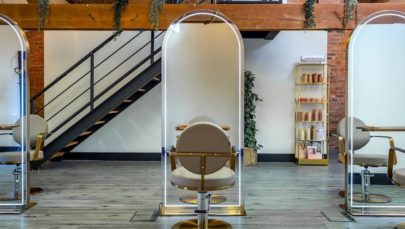 Modern salon chairs and styling stations at Utopia Hair Co, Clifton, England, GB with elegant flooring.
