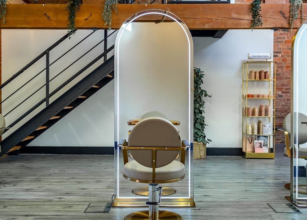 Modern salon chairs and styling stations at Utopia Hair Co, Clifton, England, GB with elegant flooring.