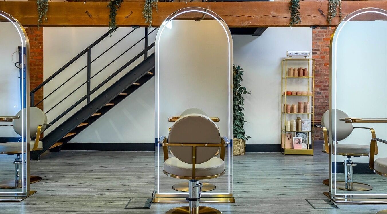 Modern salon chairs and styling stations at Utopia Hair Co, Clifton, England, GB with elegant flooring.