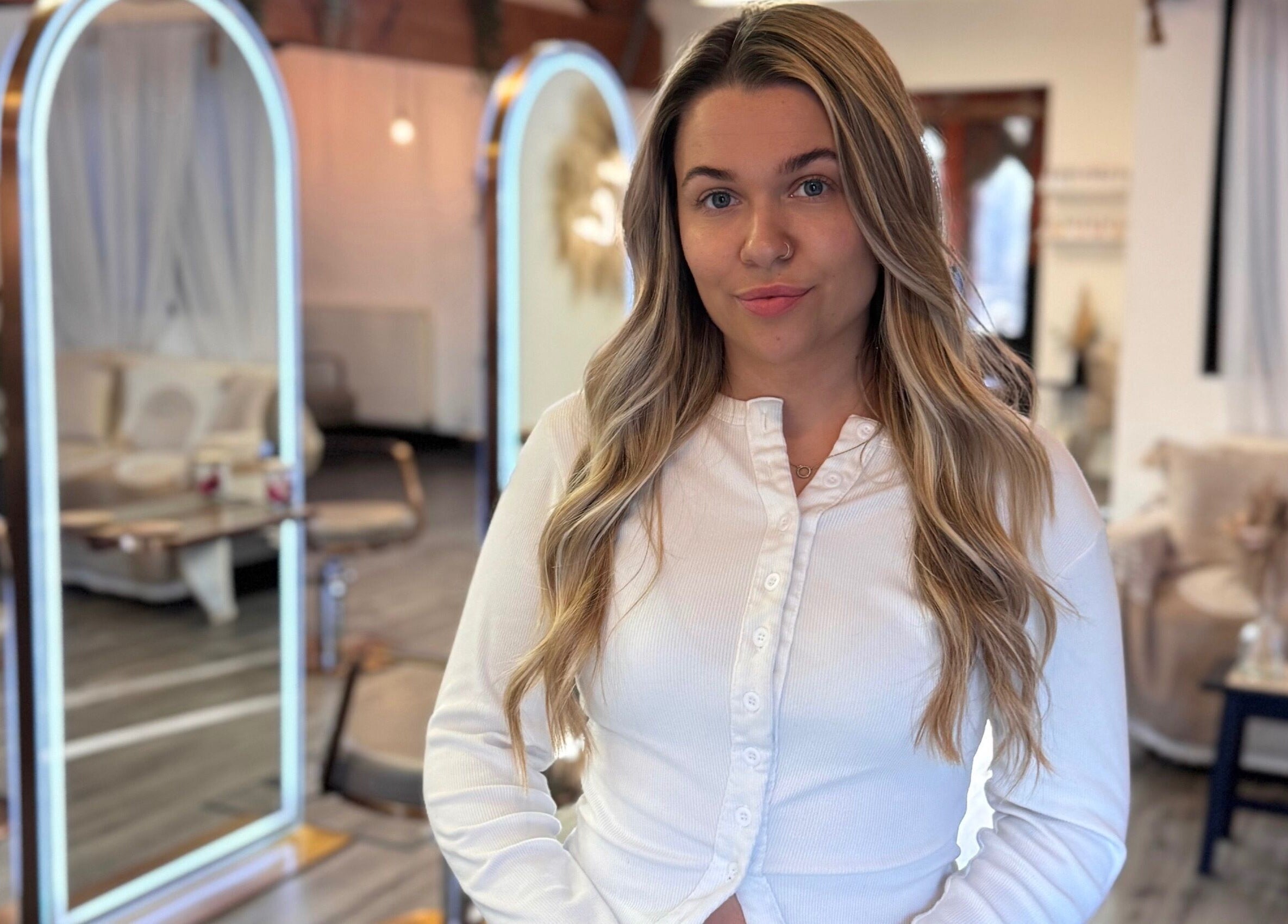 Utopia Hair Co stylist in Clifton, England, GB salon with chic decor in background.