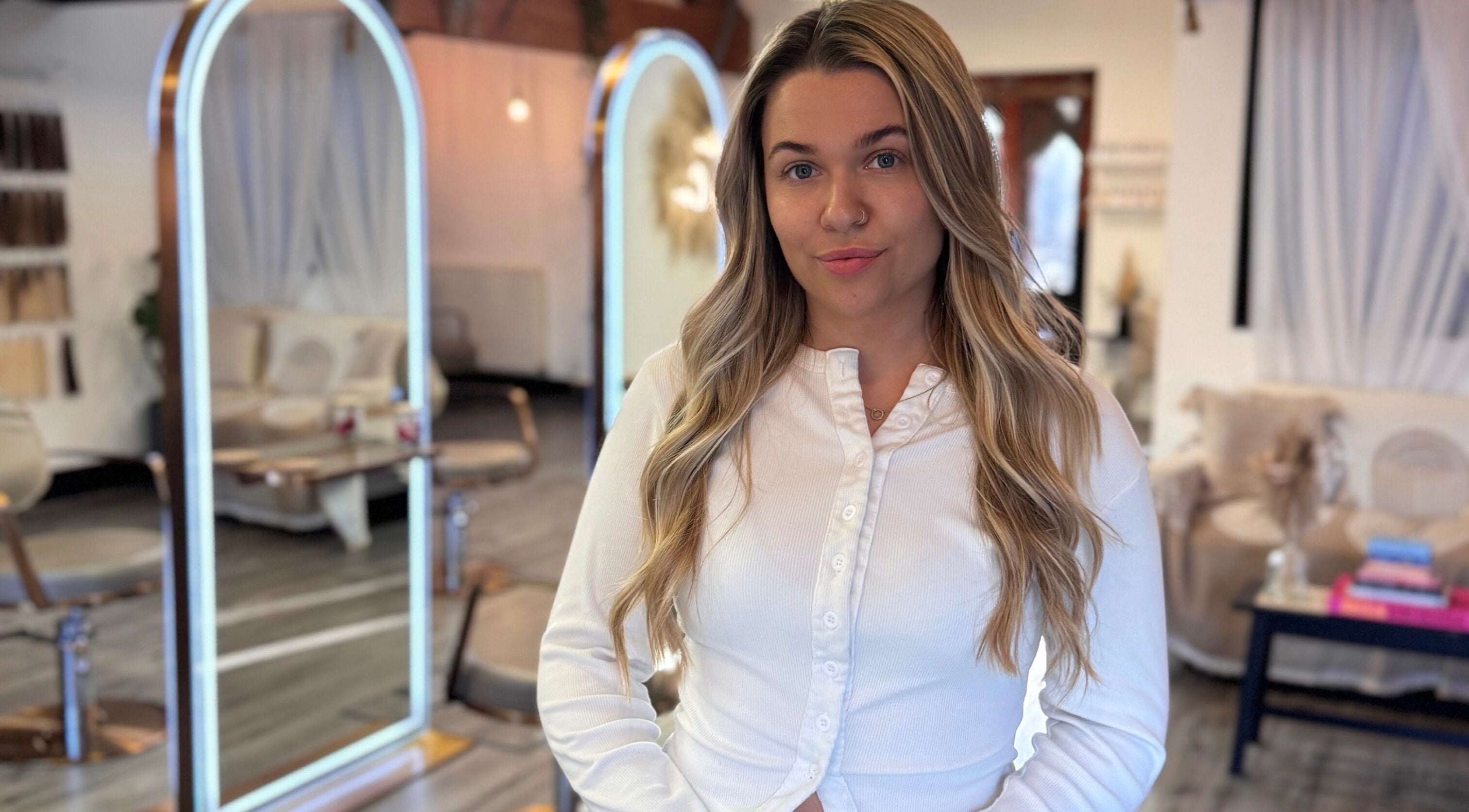 Utopia Hair Co stylist in Clifton, England, GB salon with chic decor in background.