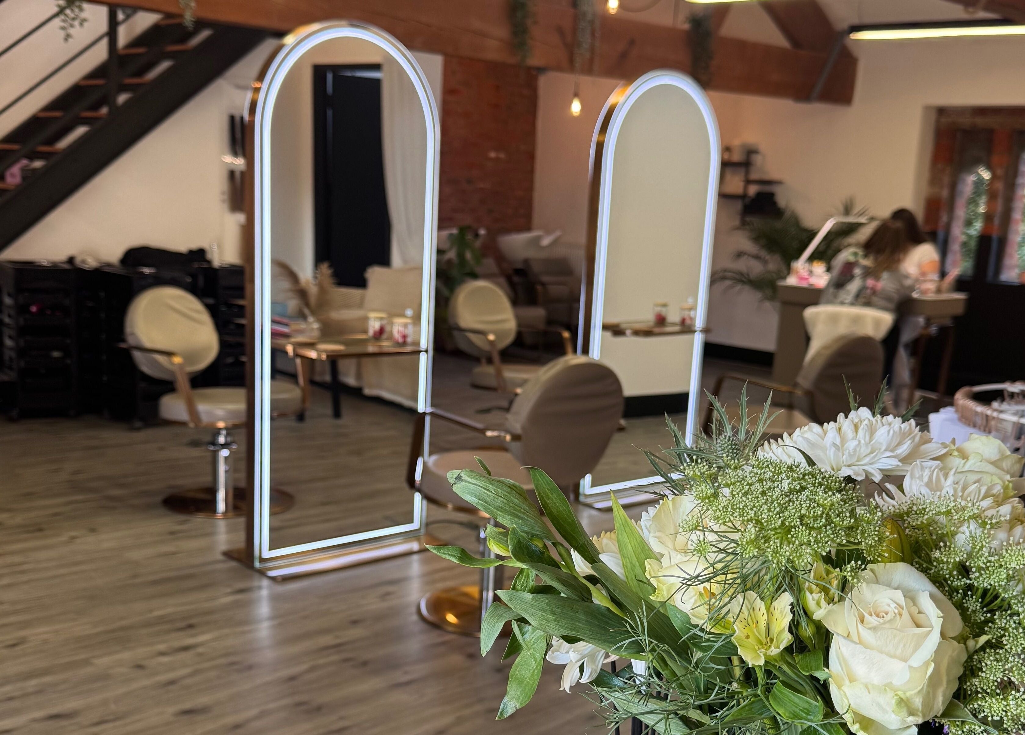 Elegant interior of Utopia Hair Co, Clifton, England, GB with stylish chairs and mirrors.