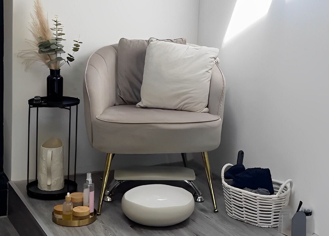 Elegant corner with plush chair at Utopia Hair Co, Clifton, England, GB, creating a serene spa ambiance.