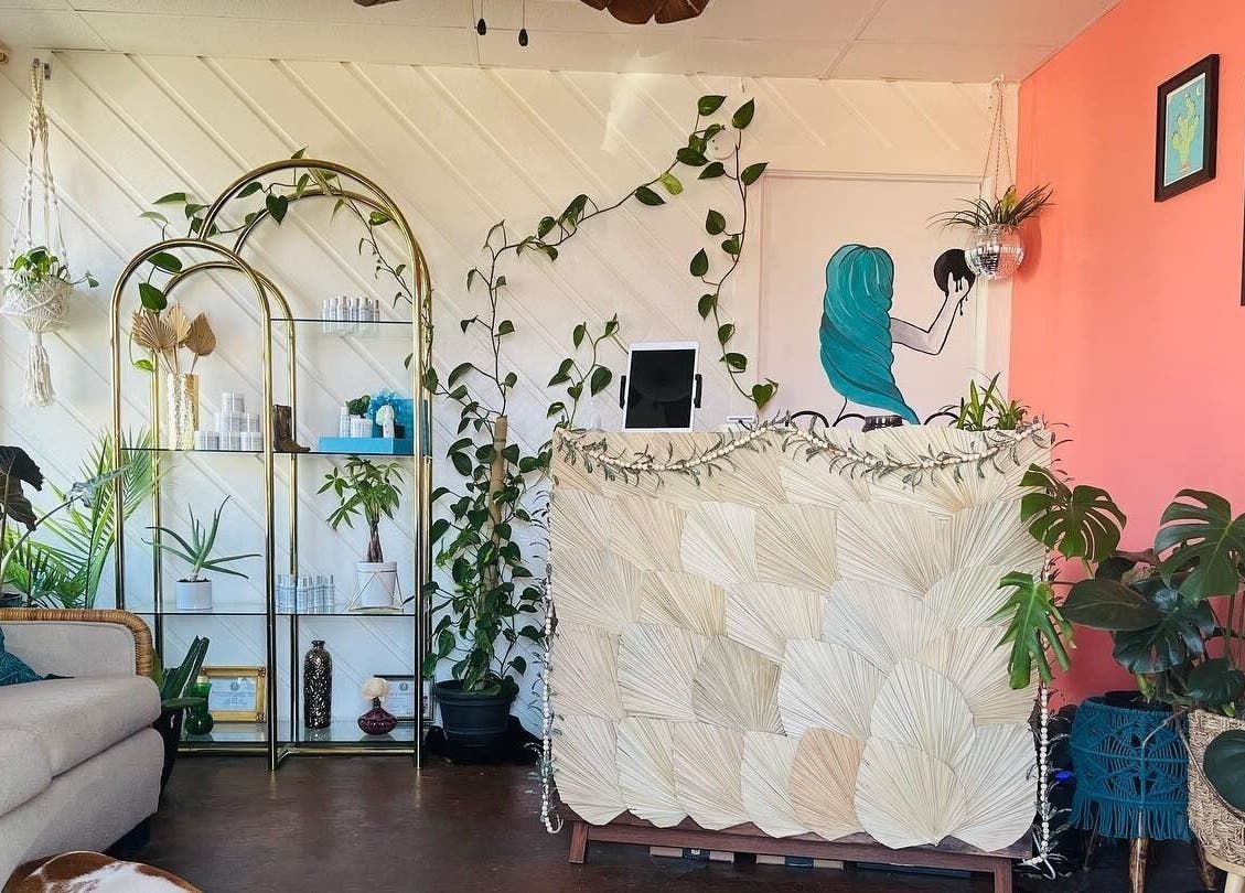 Cozy and vibrant reception at Nood Wax & Sugar ATX in Austin, Texas, US with plants and art decor.