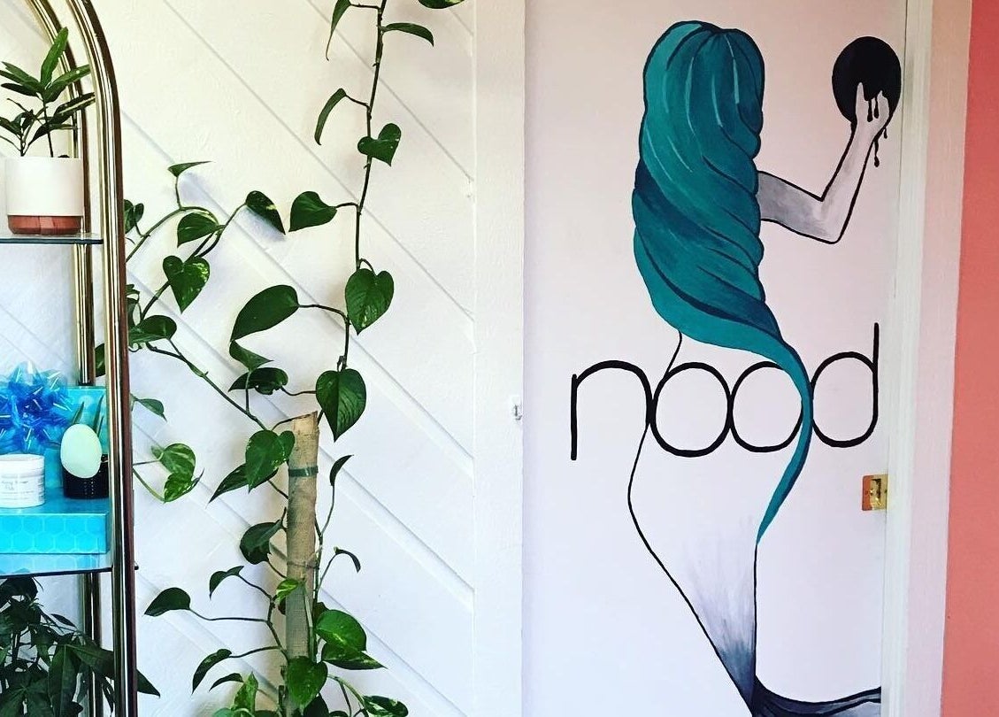 Nood Wax & Sugar ATX mural and decor in Austin, Texas US featuring vibrant art and indoor plants.