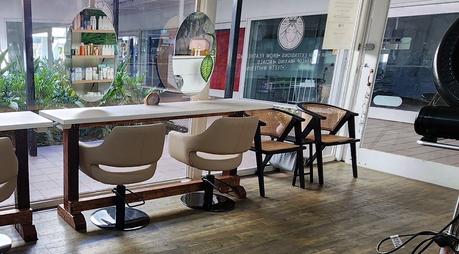 Modern salon seating at Get Goddess Hair and Beauty, Redland Bay, Queensland, AU, with lush greenery view.
