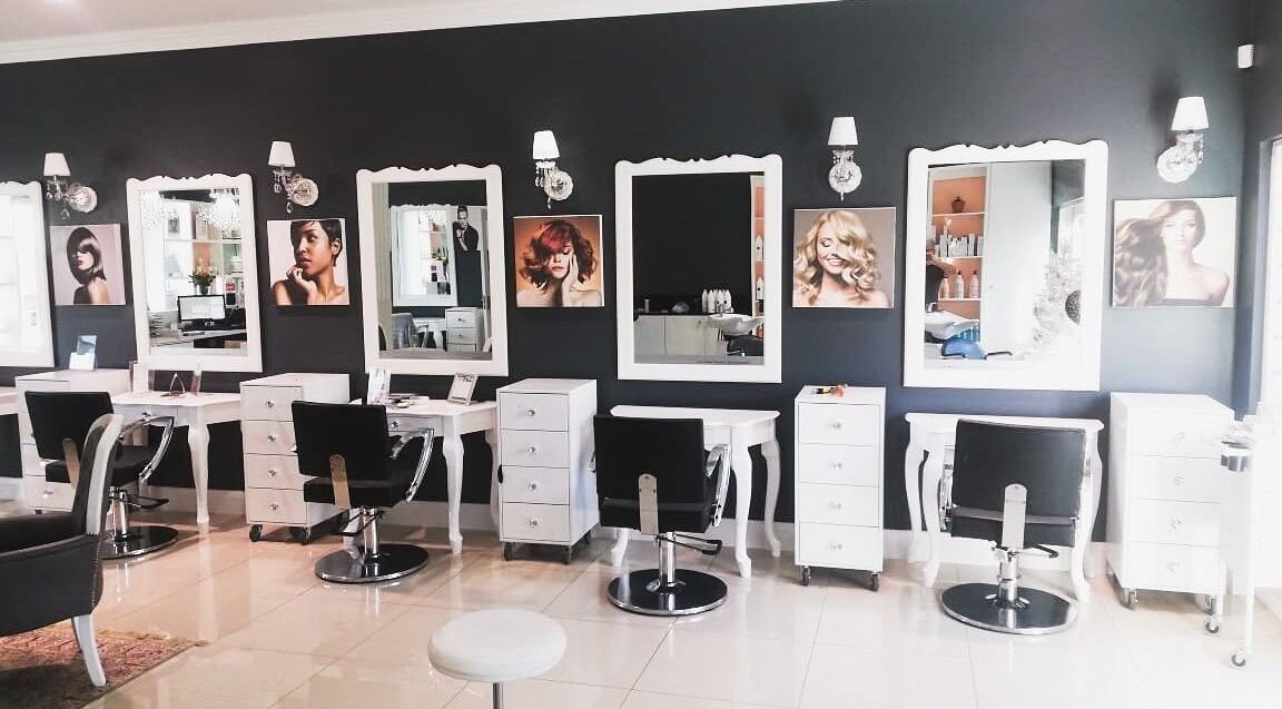 Elegant salon interior at Carley Studios Hair & Beauty in Gqeberha, Eastern Cape, ZA with stylish mirrors and chairs.