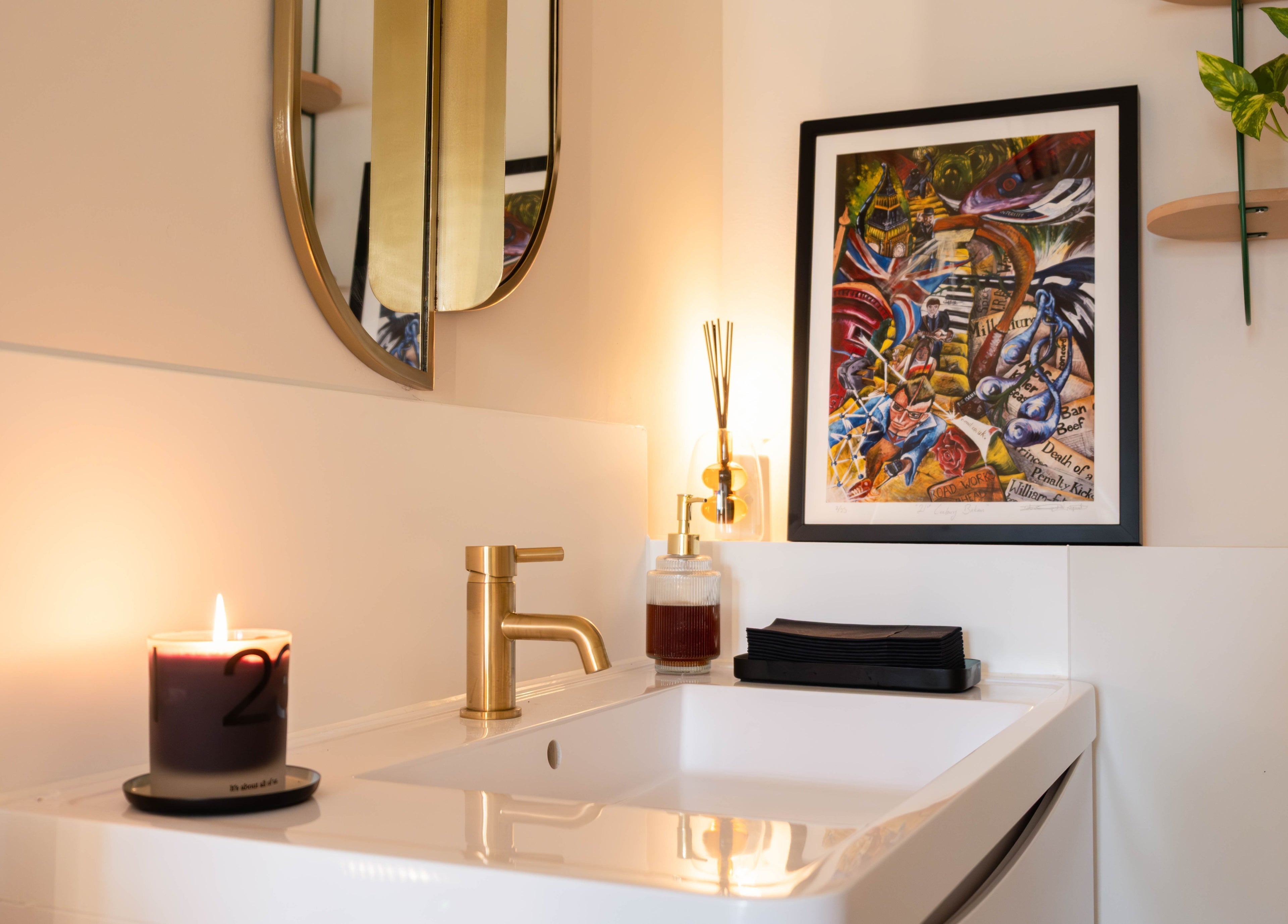 Elegant sink area at O!GLOW-ON: byAudrey.ldn, London, England, GB, featuring a candle and art piece.