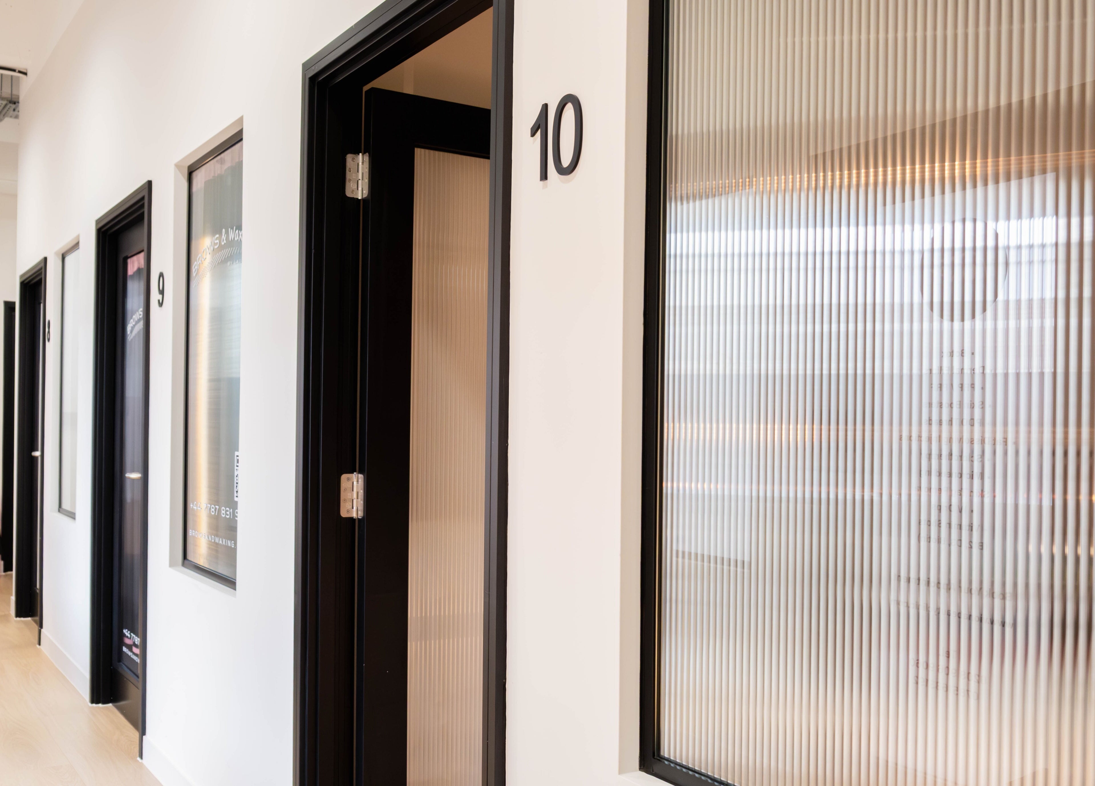 Modern hallway with numbered doors at O!GLOW-ON: byAudrey.ldn in London, England, GB.