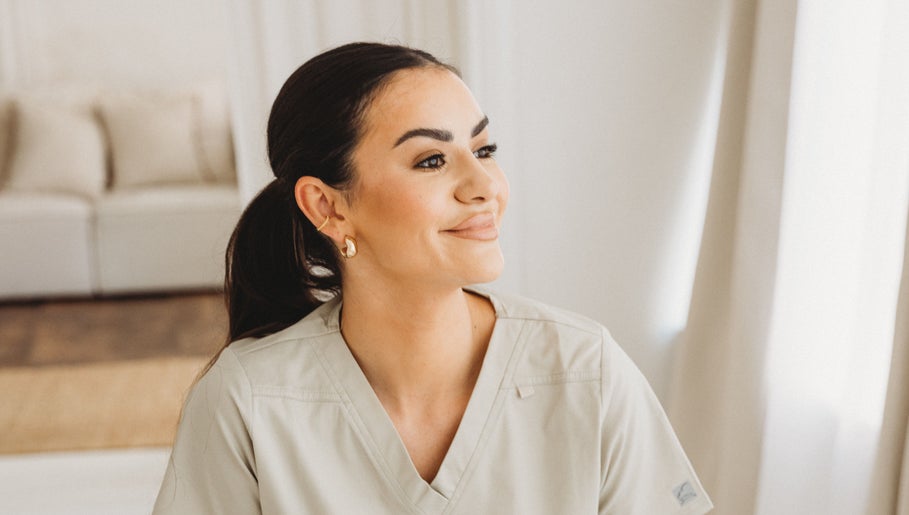Smiling staff member at Aim Medical Aesthetics - Oswestry Clinic, Oswestry, England, GB, in a calm setting.