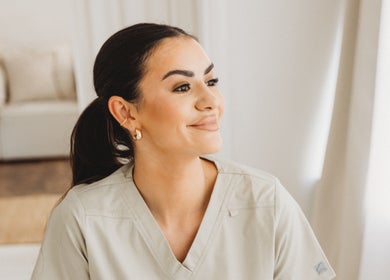Smiling staff member at Aim Medical Aesthetics - Oswestry Clinic, Oswestry, England, GB, in a calm setting.