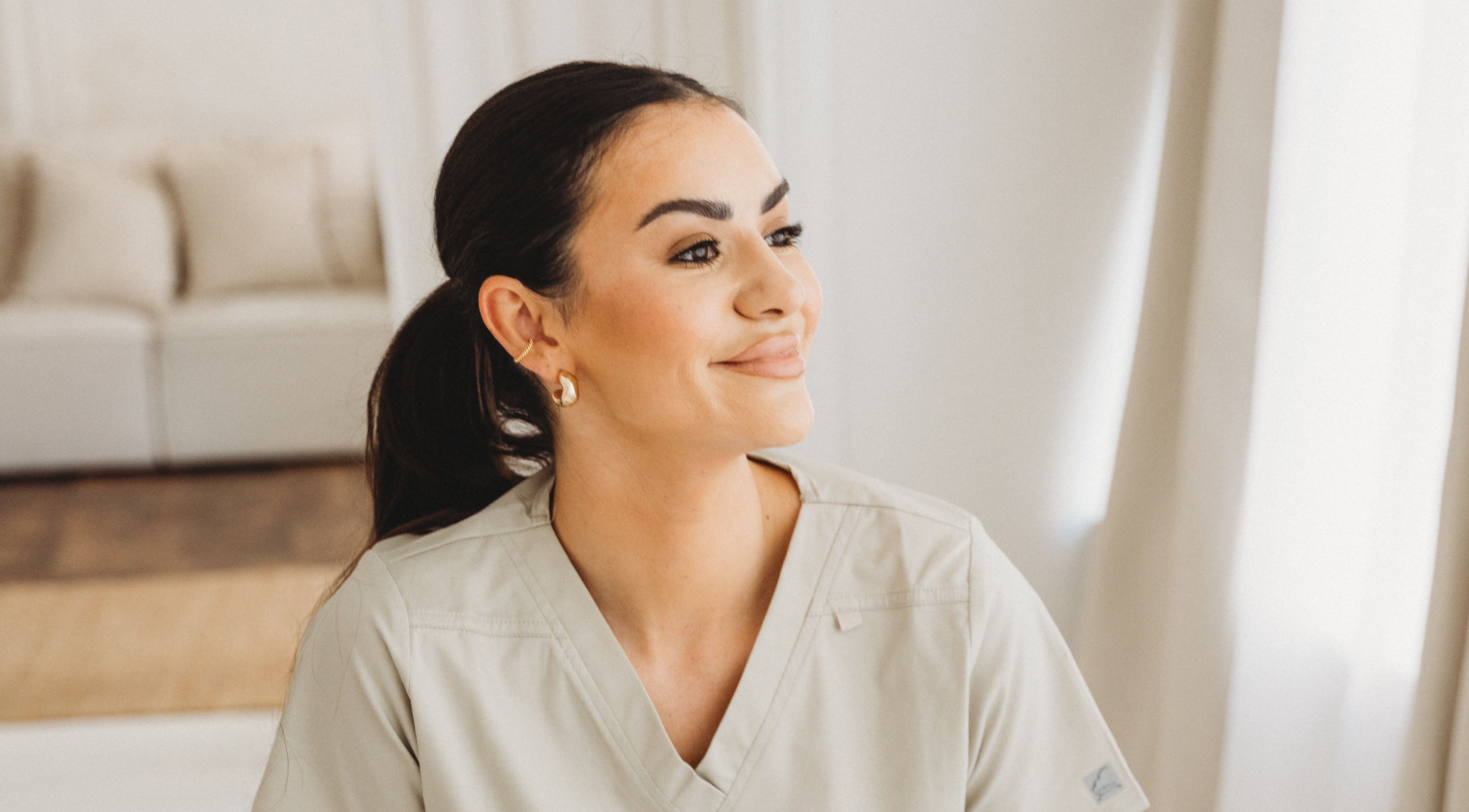Smiling staff member at Aim Medical Aesthetics - Oswestry Clinic, Oswestry, England, GB, in a calm setting.