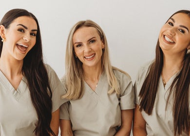 Friendly team at Aim Medical Aesthetics - Oswestry Clinic, Oswestry, England, GB, wearing beige uniforms.