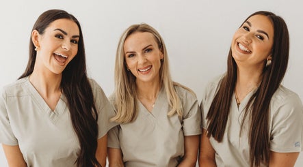 Friendly team at Aim Medical Aesthetics - Oswestry Clinic, Oswestry, England, GB, wearing beige uniforms.