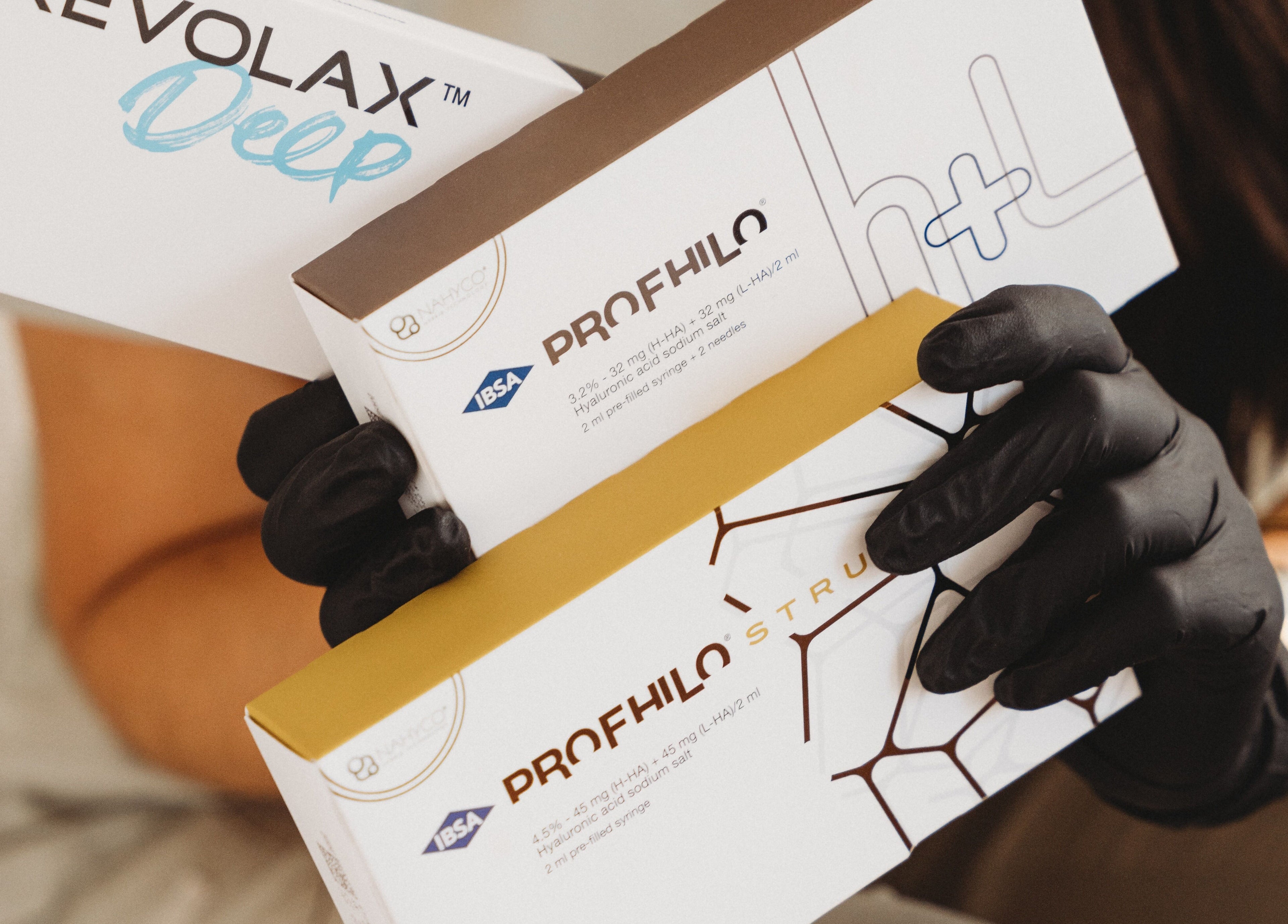 Professional holding beauty products at Aim Medical Aesthetics - Aberystwyth Clinic, Aberystwyth, Wales, GB.