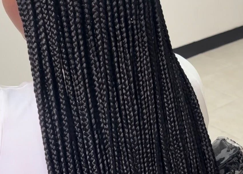 Intricate long black braids hairstyle at Braid Couturee, Bridgetown, Saint Michael, BB salon.