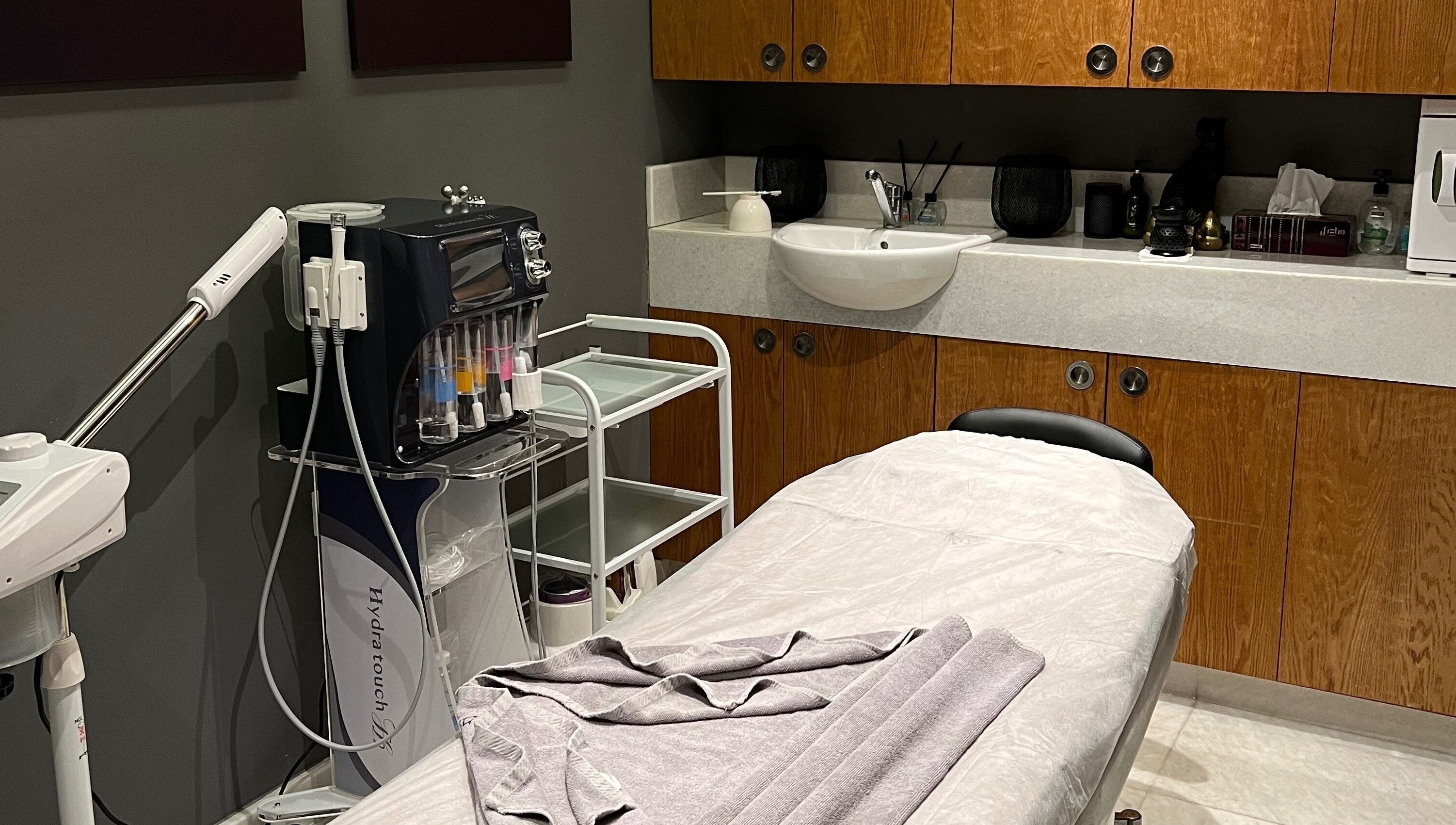 A calming treatment room at The Backyard Spa Alkhoudh in Sib, Muscat Governorate, OM, featuring a massage table.
