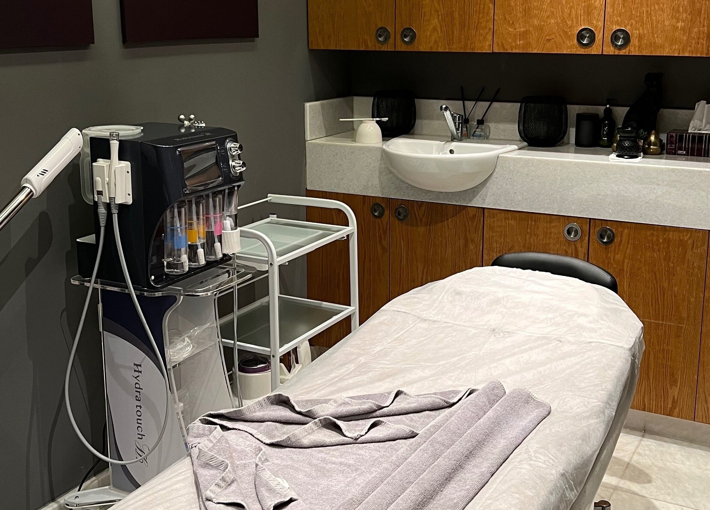A calming treatment room at The Backyard Spa Alkhoudh in Sib, Muscat Governorate, OM, featuring a massage table.