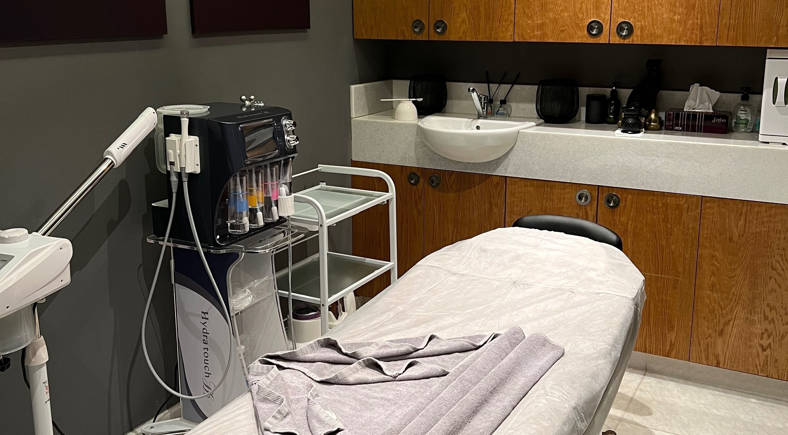 A calming treatment room at The Backyard Spa Alkhoudh in Sib, Muscat Governorate, OM, featuring a massage table.