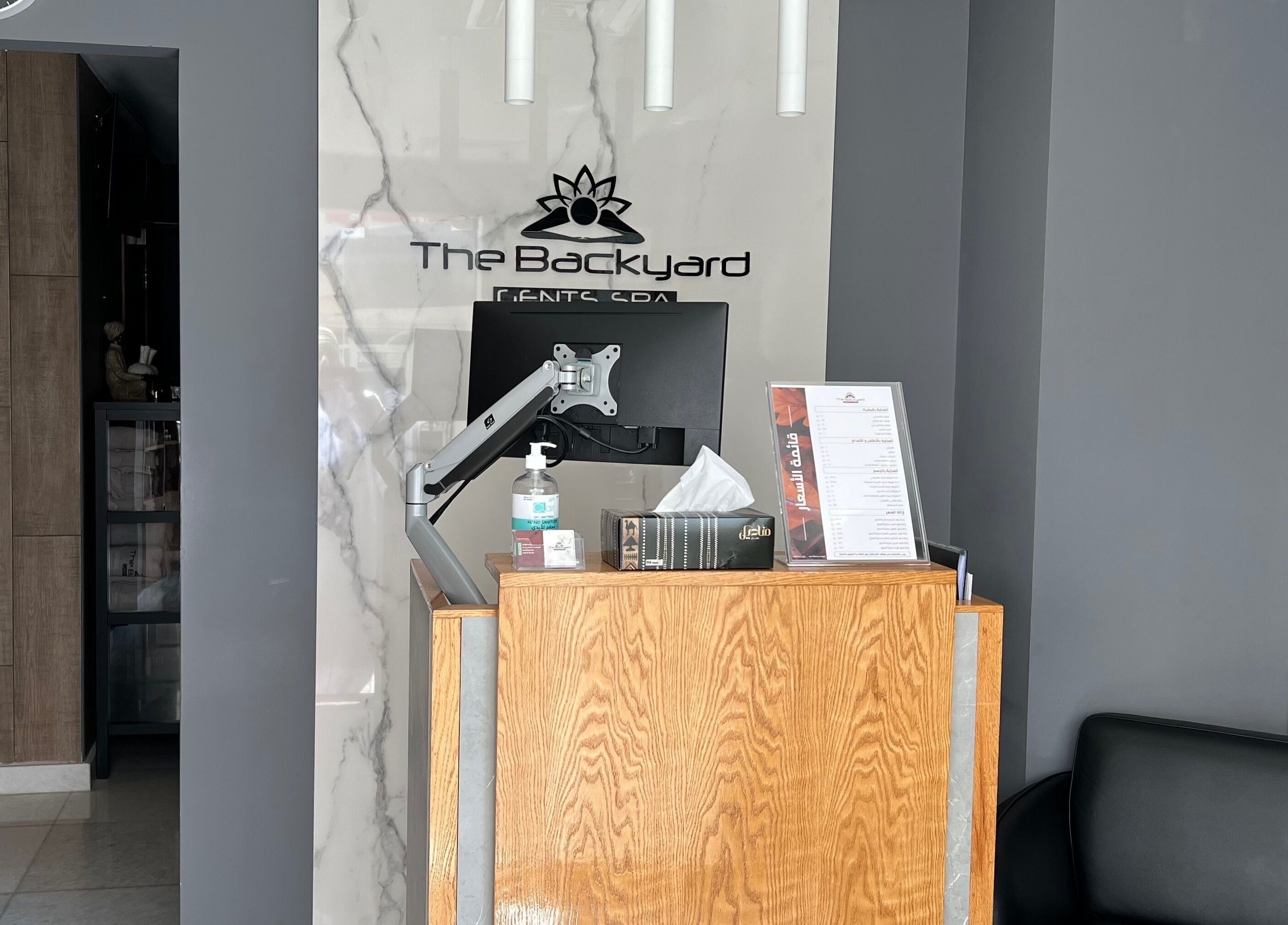 Reception desk at The Backyard Spa Alkhoudh, Sib, Muscat Governorate, OM with modern decor.