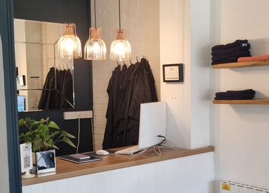Warm reception area at D&G Hairdressing, Chandler's Ford, England, with stylish lighting and decor.