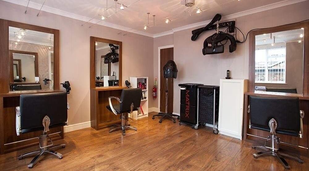 Stylish interior of Status Hair Design salon in York, England, GB featuring modern hairdressing stations.