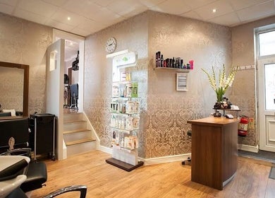 Reception area of Status Hair Design, York, England, GB, featuring sophisticated decor and beauty products.